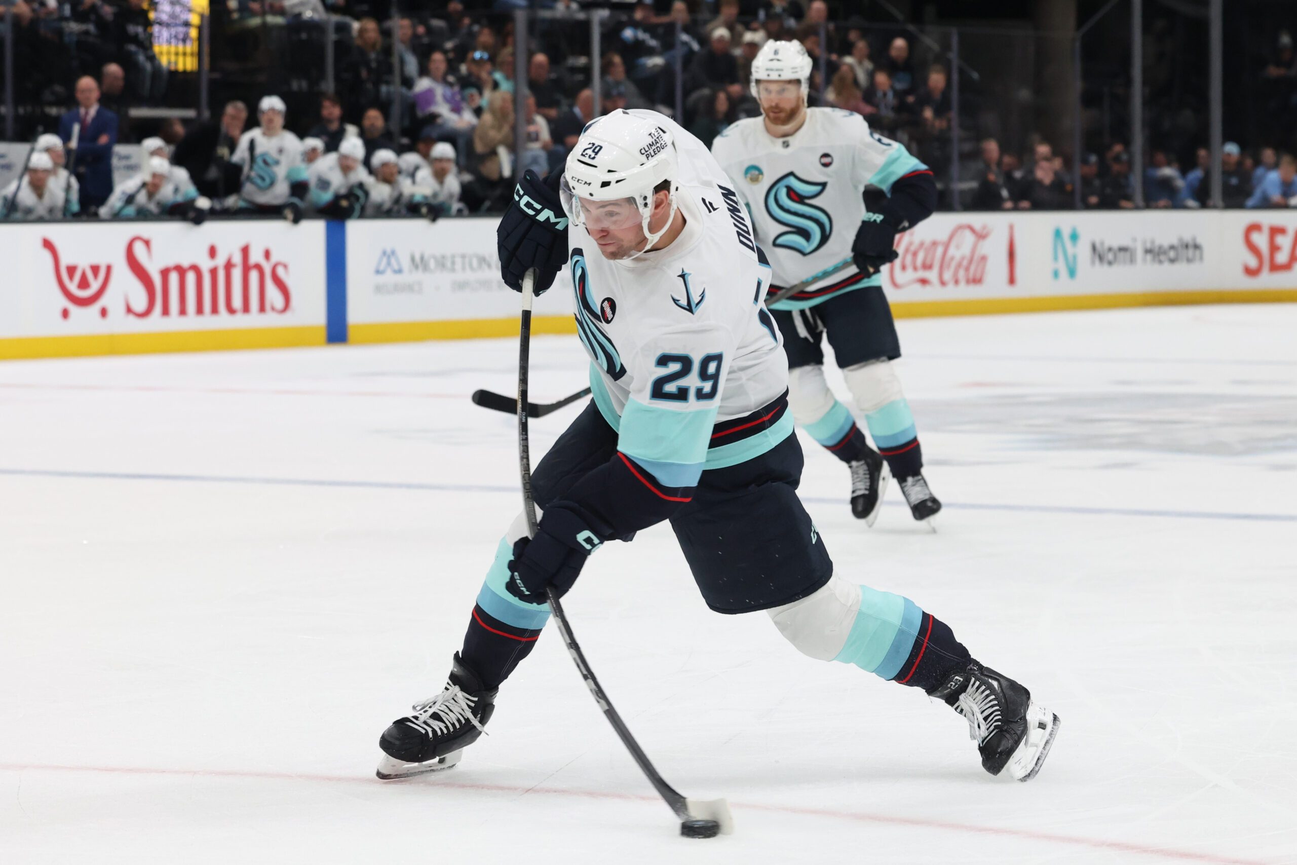 Apr 8, 2025; Salt Lake City, Utah, USA; Seattle Kraken defenseman Vince Dunn (29) takes a shot against the Utah Hockey Club during the third period at Delta Center. Mandatory Credit: Rob Gray-Imagn Images