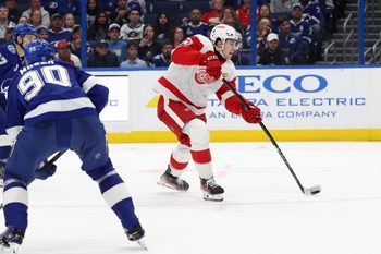Apr 11, 2025; Tampa, Florida, USA; Detroit Red Wings right wing Alex DeBrincat (93) shoots and scores the game winning goal against the Tampa Bay Lightning during overtime at Amalie Arena. Mandatory Credit: Kim Klement Neitzel-Imagn Images