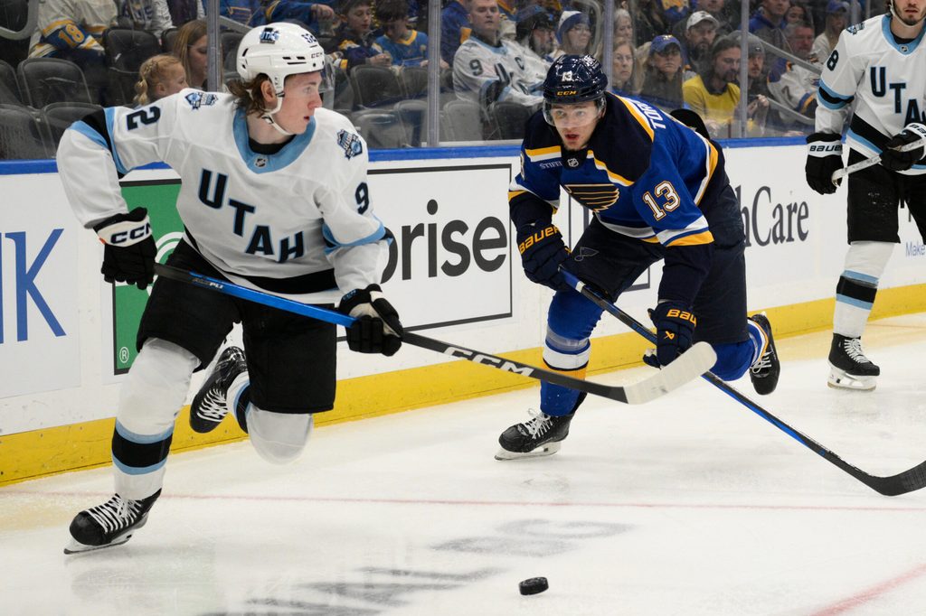 Apr 15, 2025; St. Louis, Missouri, USA; St. Louis Blues right wing Alexey Toropchenko (13) pressures Utah Hockey Club center Logan Cooley (92) during the second period at Enterprise Center. Mandatory Credit: Jeff Le-Imagn Images