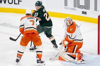 Apr 15, 2025; Saint Paul, Minnesota, USA; Anaheim Ducks goaltender Lukas Dostal (1) makes a save with defenseman Radko Gudas (7) and Minnesota Wild center Marco Rossi (23) fighting for position in front of him in the third period at Xcel Energy Center. Mandatory Credit: Matt Blewett-Imagn Images
