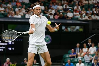 Jun 30, 2025; Wimbledon, United Kingdom; Arthur Rinderknech (FRA) hits a forehand against Alexander Zverev (GER)(not pictured) on day one of The Championships, Wimbledon 2025 at All England Lawn Tennis and Croquet Club. Mandatory Credit: Geoff Burke-Imagn Images