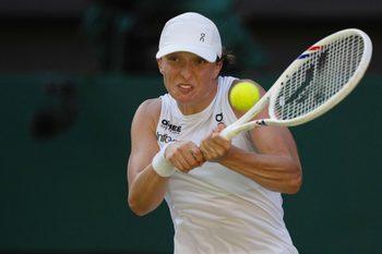 Jul 10, 2025; Wimbledon, United Kingdom; Iga Swiatek of Poland returns a shot during her match against Belinda Bencic of Switzerland on day 11 at All England Lawn Tennis and Croquet Club. Mandatory Credit: Susan Mullane-Imagn Images