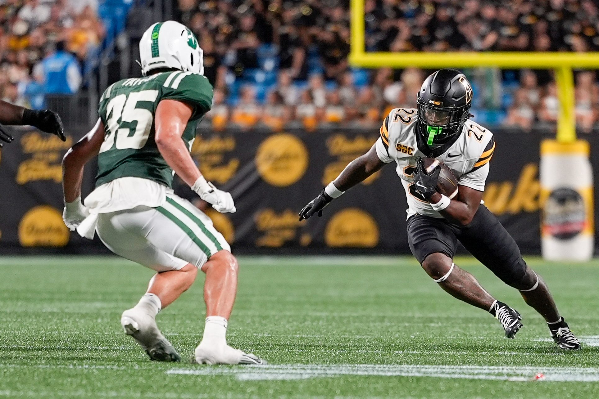 Aug 29, 2025; Charlotte, North Carolina, USA; Appalachian State Mountaineers running back Jaquari Lewis (22) tries to elude Charlotte 49ers linebacker Shay Taylor (35) during the second half at Bank of America Stadium. Mandatory Credit: Jim Dedmon-Imagn Images