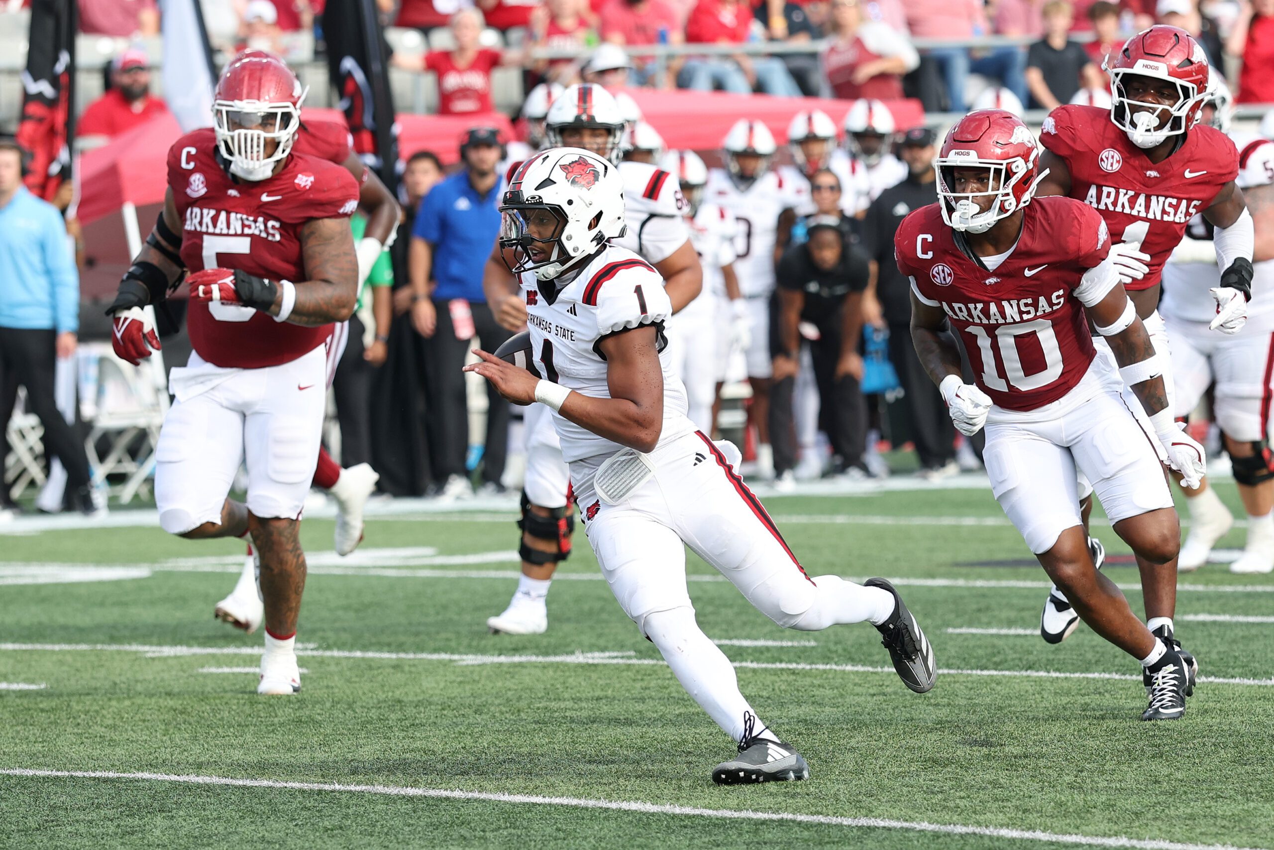 Sep 6, 2025; Little Rock, Arkansas, USA; Arkansas Razorbacks quarterback Jaylen Raynor (1) rushes in the second quarter against the Arkansas State Red Wolves at War Memorial Stadium. Mandatory Credit: Nelson Chenault-Imagn Images