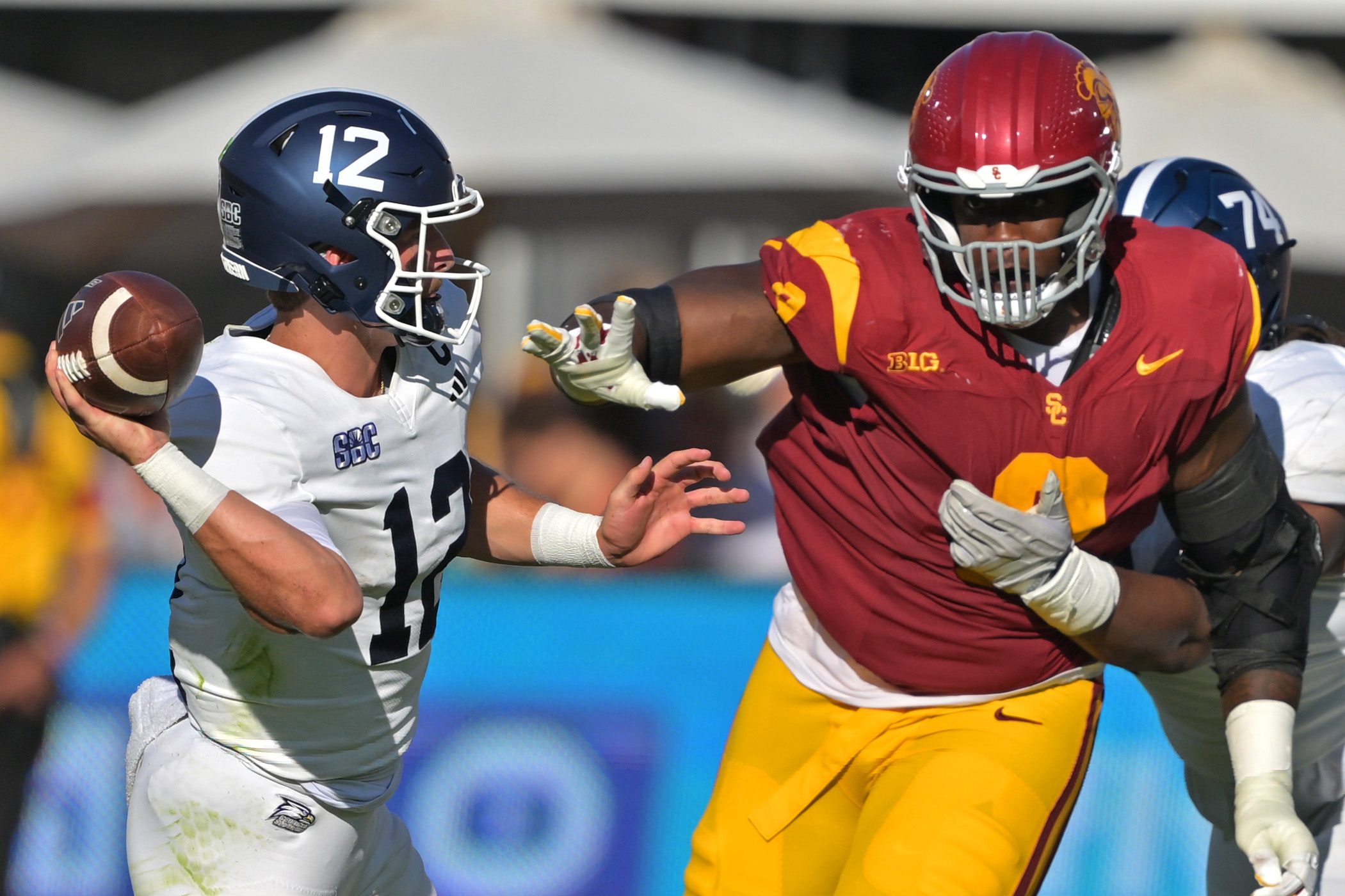 Sep 6, 2025; Los Angeles, California, USA;  Georgia Southern Eagles quarterback JC French IV (12) is pressured by Trojans defensive tackle Devan Thompkins (8) during the first half at United Airlines Field at the Los Angeles Memorial Coliseum. Mandatory Credit: Jayne Kamin-Oncea-Imagn Images