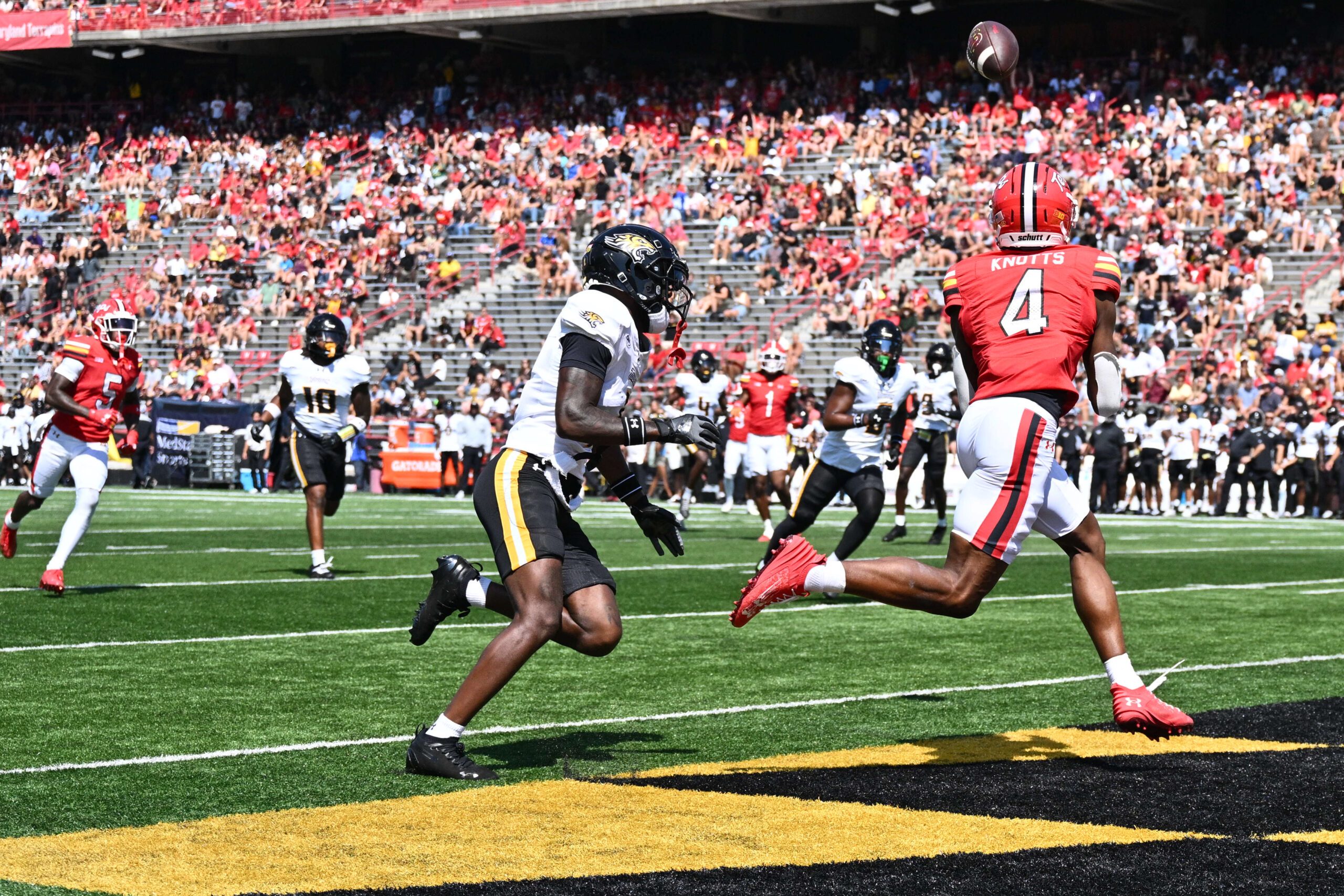 Sep 13, 2025; College Park, Maryland, USA;  Maryland Terrapins wide receiver Shaleak Knotts (4) catches a touchdown pass in the first half against the Towson Tigers at SECU Stadium. Mandatory Credit: Jamie Sabau-Imagn Images