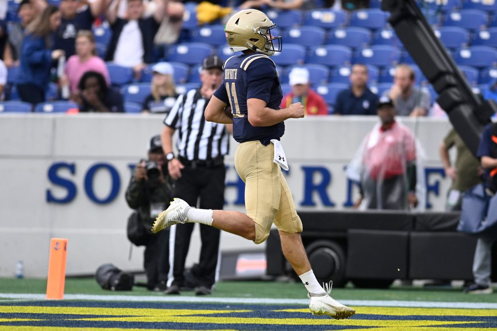 Sep 27, 2025; Annapolis, Maryland, USA; Navy Midshipmen quarterback Blake Horvath (11) scores a first half touchdown against the Rice Owls at Navy-Marine Corps Memorial Stadium. Mandatory Credit: Tommy Gilligan-Imagn Images