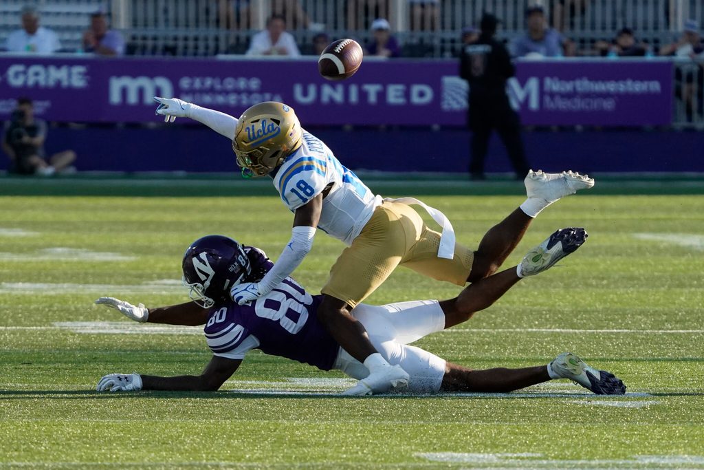Sep 27, 2025; Evanston, Illinois, USA; UCLA Bruins defensive back Rodrick Pleasant (18) defends Northwestern Wildcats wide receiver Hayden Eligon II (80) during the second half at Northwestern Medicine Field at Martin Stadium. Mandatory Credit: David Banks-Imagn Images