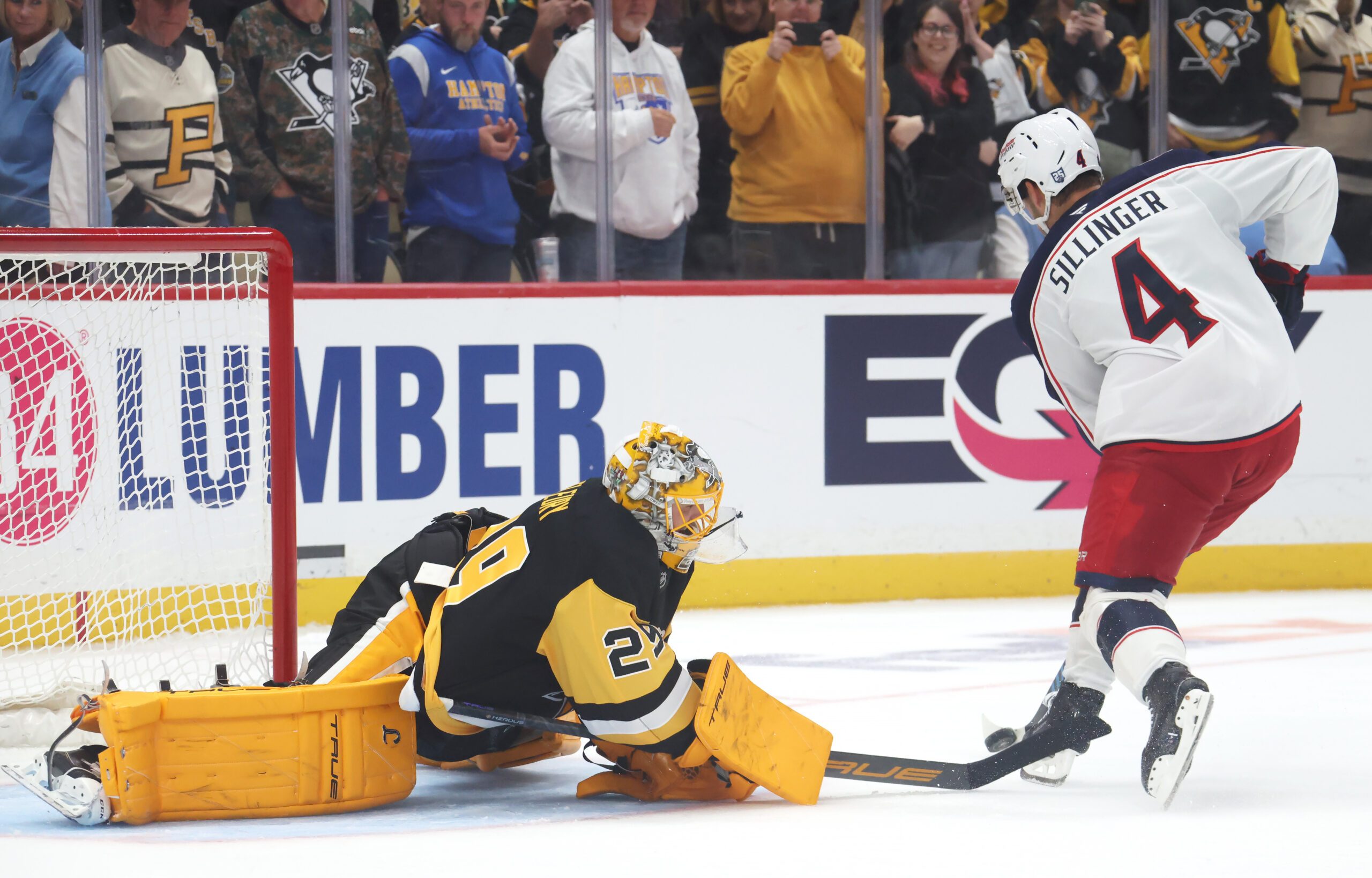 Sep 27, 2025; Pittsburgh, Pennsylvania, USA;  Pittsburgh Penguins goaltender Marc-Andre Fleury (29) poke checks the puck from Columbus Blue Jackets center Cole Sillinger (4) in the shootout at PPG Paints Arena. Mandatory Credit: Charles LeClaire-Imagn Images
