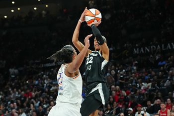 Oct 3, 2025; Las Vegas, Nevada, USA; Las Vegas Aces center A'ja Wilson (22) shoots against Phoenix Mercury forward Alyssa Thomas (25) during the fourth quarter of game one of the 2025 WNBA Finals at Michelob Ultra Arena. Mandatory Credit: Stephen R. Sylvanie-Imagn Images