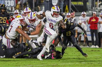 Oct 4, 2025; Orlando, Florida, USA; Kansas Jayhawks quarterback Jalon Daniels (6) carries the ball during the second quarter against the UCF Knights at FBC Mortgage Stadium. Mandatory Credit: Mike Watters-Imagn Images