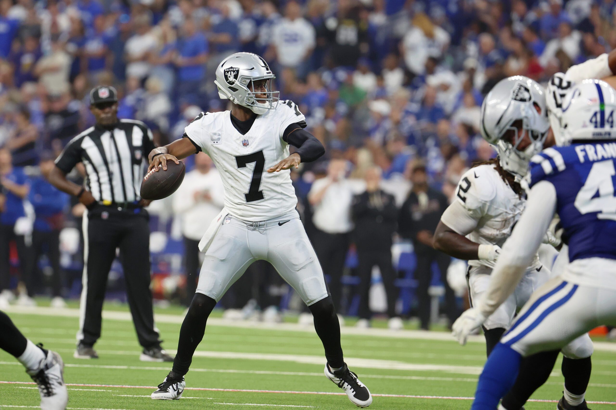 Oct 5, 2025; Indianapolis, Indiana, USA; Las Vegas Raiders quarterback Geno Smith (7) looks to pass the ball against the Indianapolis Colts during the second quarter at Lucas Oil Stadium. Mandatory Credit: Trevor Ruszkowski-Imagn Images