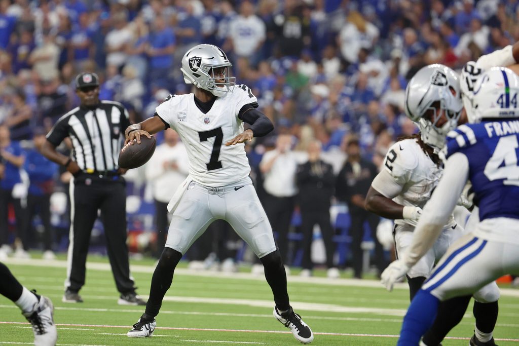 Oct 5, 2025; Indianapolis, Indiana, USA; Las Vegas Raiders quarterback Geno Smith (7) looks to pass the ball against the Indianapolis Colts during the second quarter at Lucas Oil Stadium. Mandatory Credit: Trevor Ruszkowski-Imagn Images