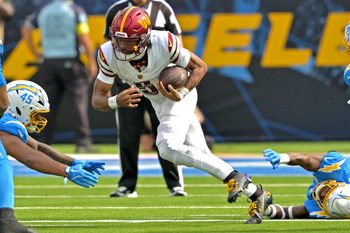 Oct 5, 2025; Inglewood, California, USA; Washington Commanders quarterback Jayden Daniels (5) runs for a first down against the Los Angeles Chargers at SoFi Stadium. Mandatory Credit: Jayne Kamin-Oncea-Imagn Images