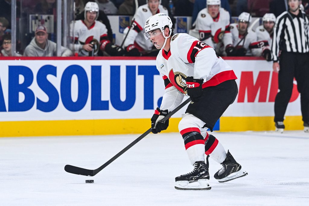 Oct 4, 2025; Montreal, Quebec, CAN; Ottawa Senators center Shane Pinto (12) plays the puck against the Montreal Canadiens during the second period at Bell Centre. Mandatory Credit: David Kirouac-Imagn Images