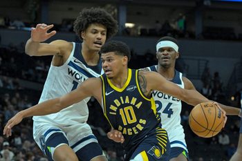 Oct 7, 2025; Minneapolis, Minnesota, USA; Indiana Pacers guard RayJ Dennis (10) drives the lane as Minnesota Timberwolves center Joan Beringer (19) defends during the fourth quarter at Target Center. Mandatory Credit: Nick Wosika-Imagn Images