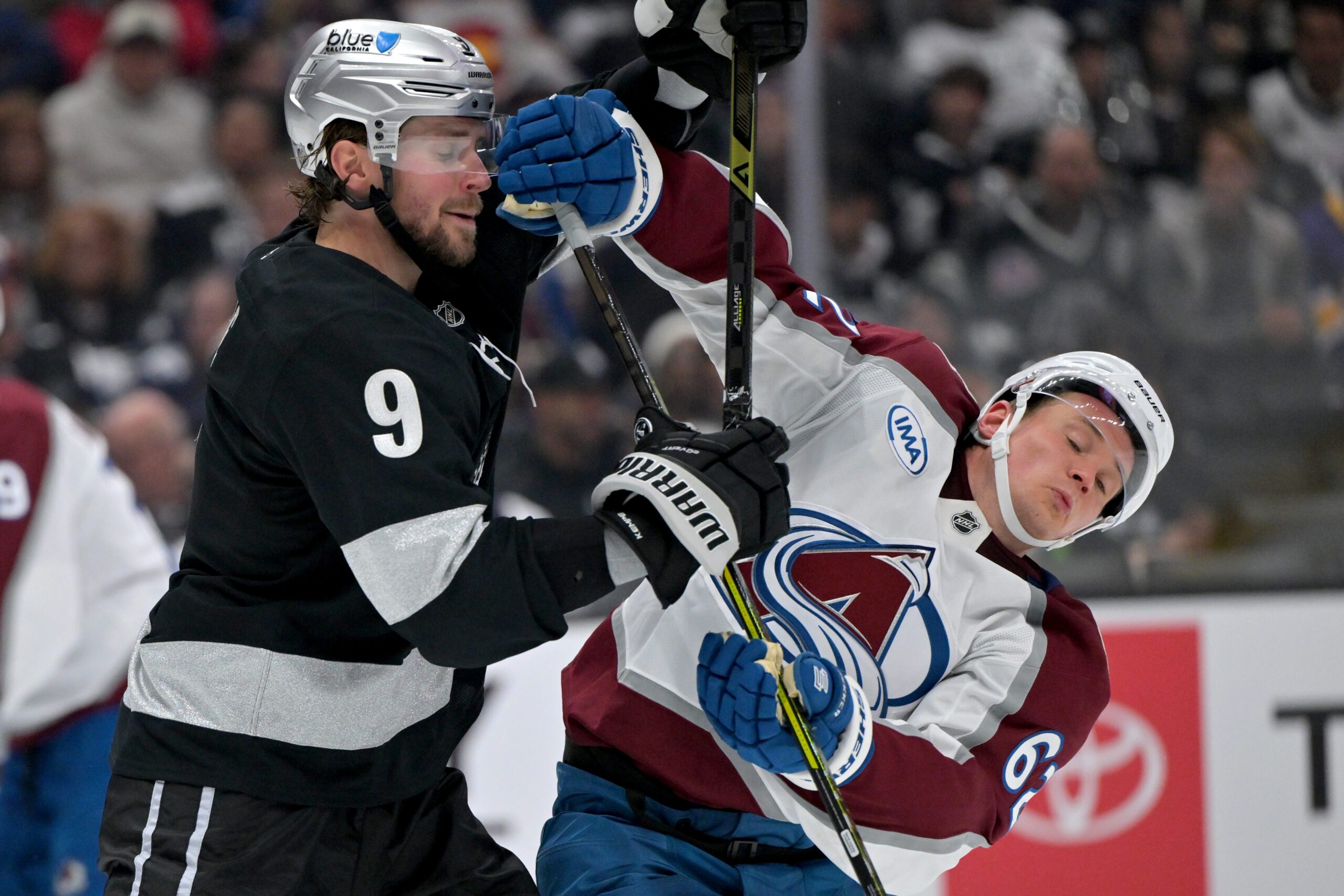 Oct 7, 2025; Los Angeles, California, USA;  Los Angeles Kings right wing Adrian Kempe (9) and Colorado Avalanche left wing Artturi Lehkonen (62) battle for position on the ice during the third period at Crypto.com Arena. Mandatory Credit: Jayne Kamin-Oncea-Imagn Images