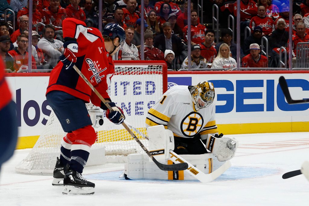 Oct 8, 2025; Washington, District of Columbia, USA; Boston Bruins goaltender Jeremy Swayman (1) makes a save against in front of Washington Capitals defenseman Jakob Chychrun (6) during the first period at Capital One Arena. Mandatory Credit: Geoff Burke-Imagn Images