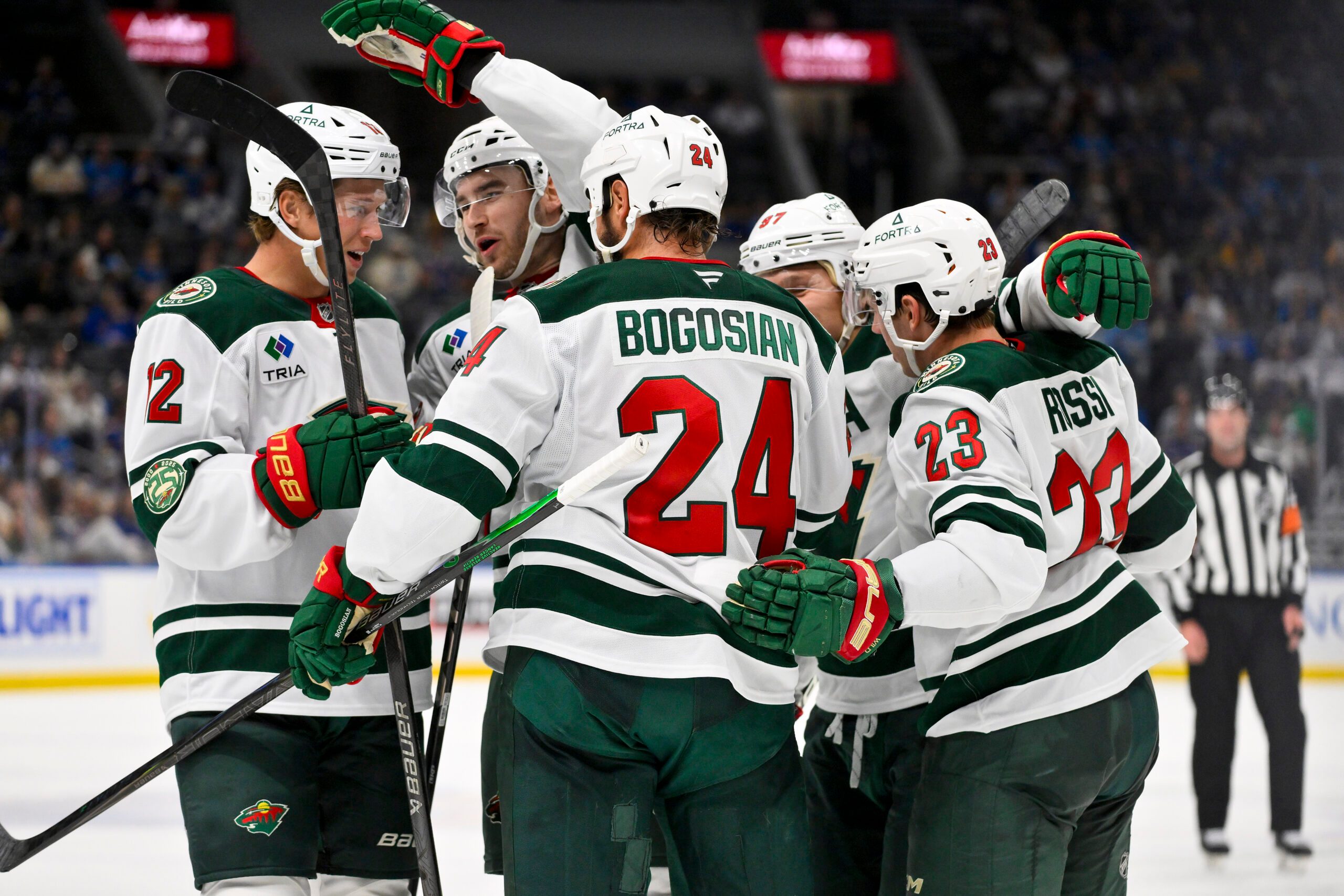 Oct 9, 2025; St. Louis, Missouri, USA; Minnesota Wild center Marco Rossi (23) is congratulated by teammates after scoring against the St. Louis Blues during the third period at Enterprise Center. Mandatory Credit: Jeff Curry-Imagn Images
