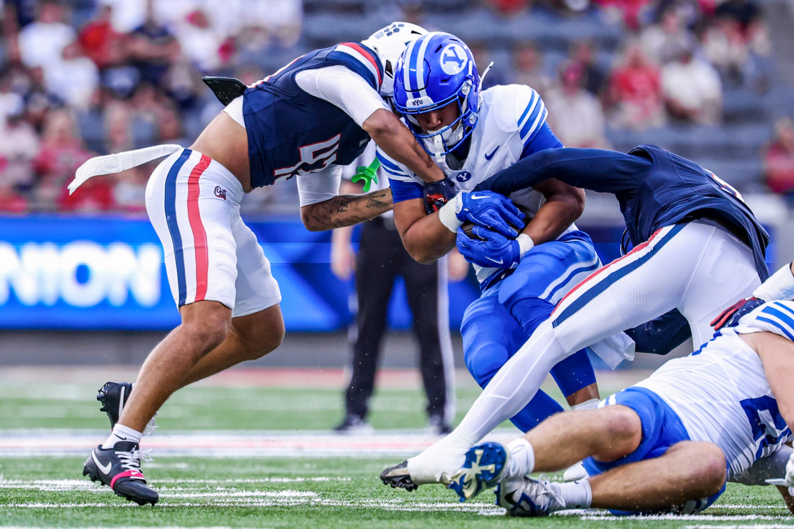 Oct 11, 2025; Tucson, Arizona, USA; Brigham Young Cougars running back LJ Martin (4) gets tackled by Arizona Wildcats defensive back Dalton Johnson (43) during the first quarter of the game at Arizona Stadium. Mandatory Credit: Aryanna Frank-Imagn Images