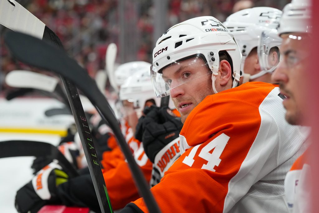 Oct 11, 2025; Raleigh, North Carolina, USA; Philadelphia Flyers center Sean Couturier (14) looks on from the players bench against the Carolina Hurricanes during the first period at Lenovo Center. Mandatory Credit: James Guillory-Imagn Images