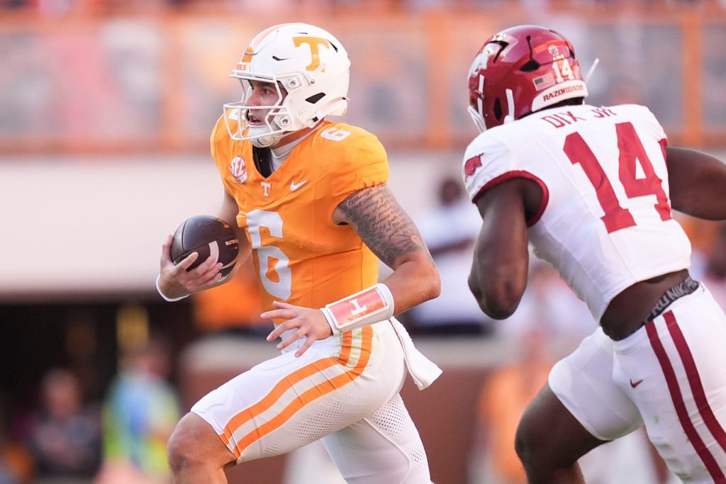 Arkansas wide receiver Raylen Sharpe (6) runs the ball as Arkansas linebacker Stephen Dix Jr. (14) pursues in an NCAA college football game on Oct. 11, 2025, in Knoxville, Tennessee.