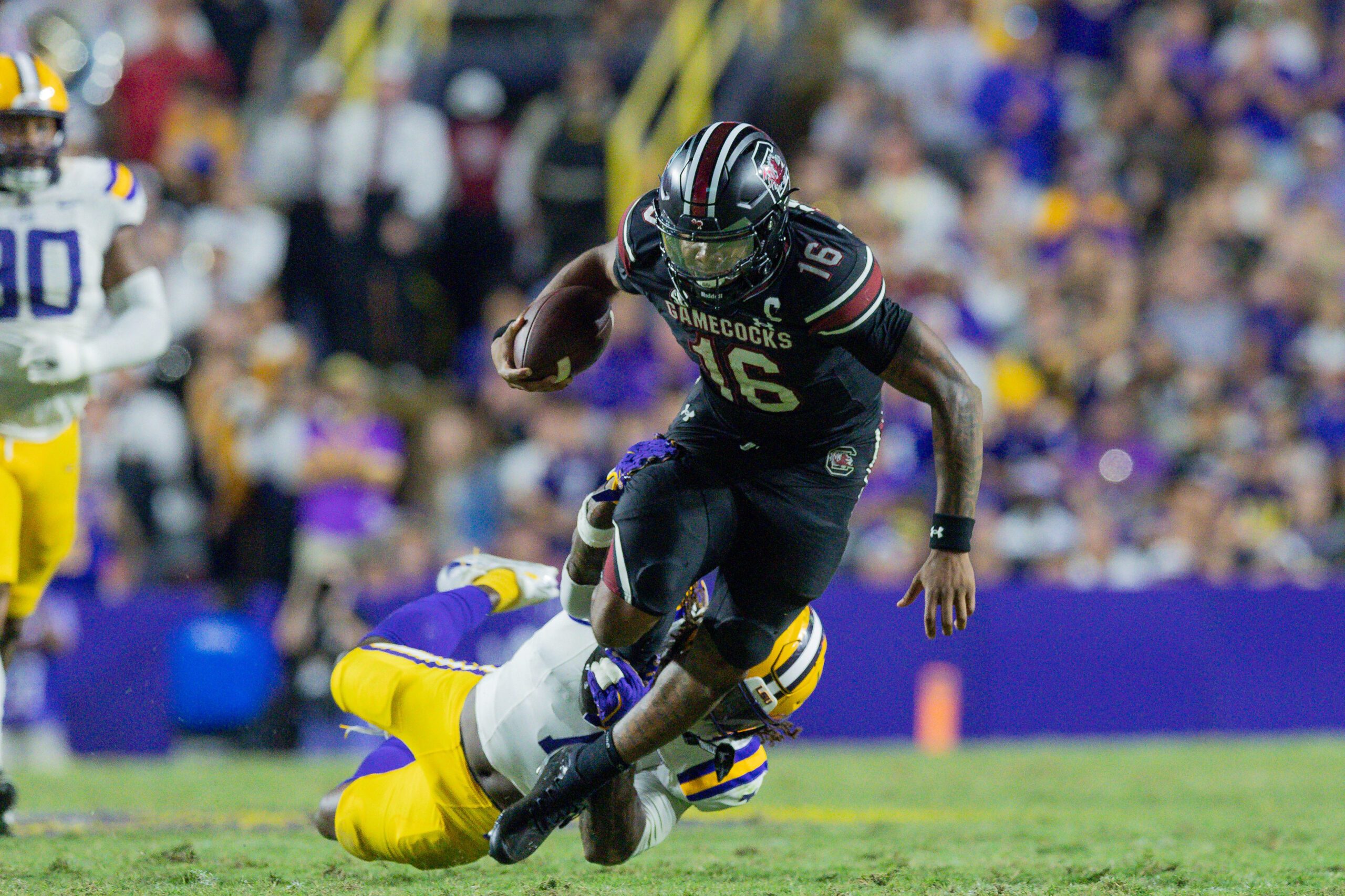 Oct 11, 2025; Baton Rouge, Louisiana, USA;  LSU Tigers linebacker Harold Perkins Jr. (7) tackles South Carolina Gamecocks quarterback Lanorris Sellers (16) during the second half at Tiger Stadium. Mandatory Credit: Stephen Lew-Imagn Images