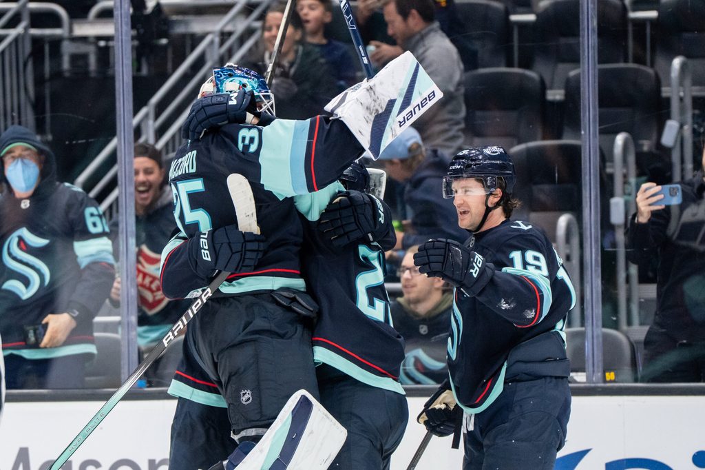 Oct 11, 2025; Seattle, Washington, USA; Seattle Kraken forward Jared McCann (19) celebrates with defenseman Joey Daccord (35) and defenseman Vince Dunn (29) after scoring a goal in overtime against against the Vegas Golden Knights at Climate Pledge Arena. Mandatory Credit: Stephen Brashear-Imagn Images