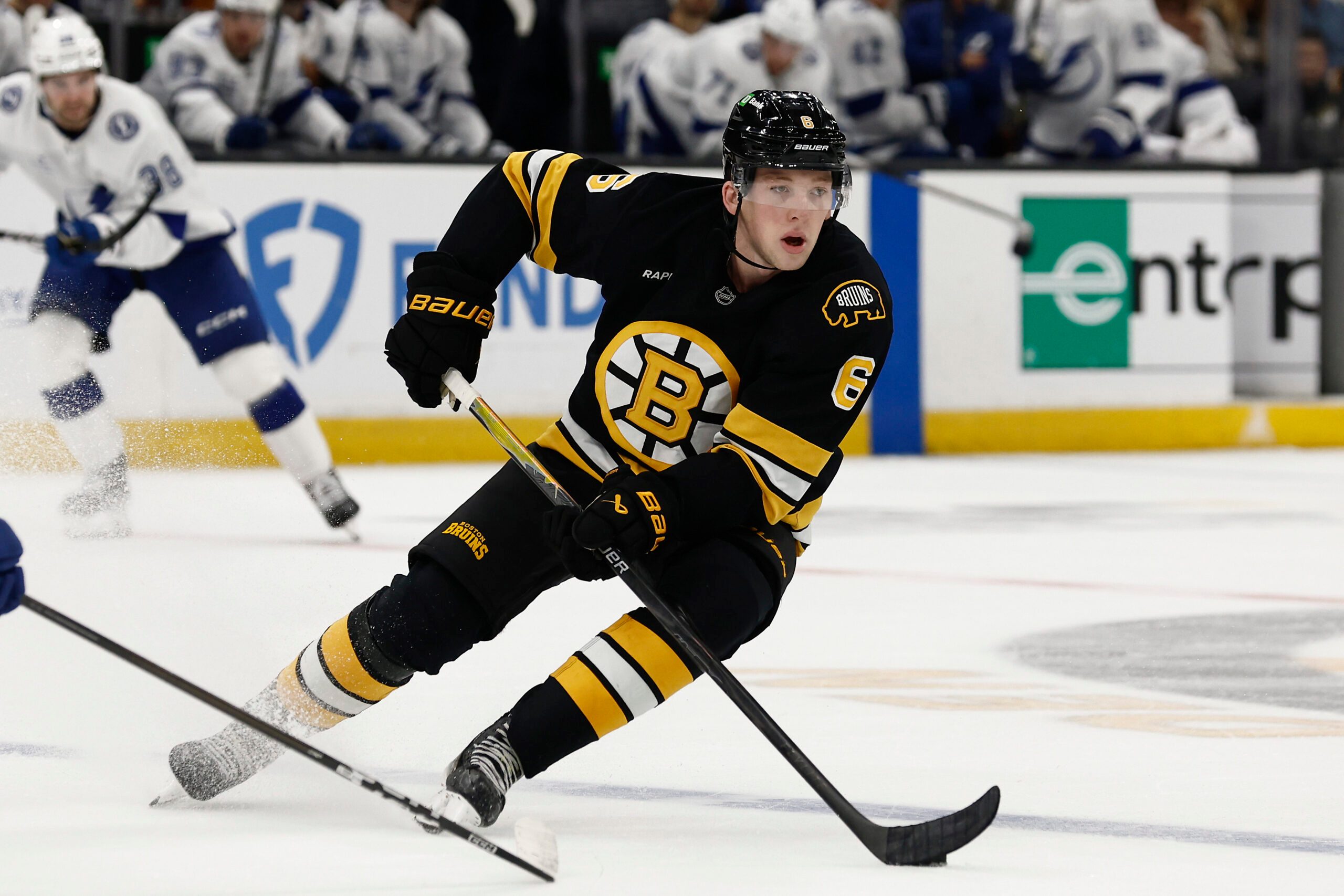 Oct 13, 2025; Boston, Massachusetts, USA; Boston Bruins defenseman Mason Lohrei (6) carries the puck during the second period against the Tampa Bay Lightning at TD Garden. Mandatory Credit: Winslow Townson-Imagn Images