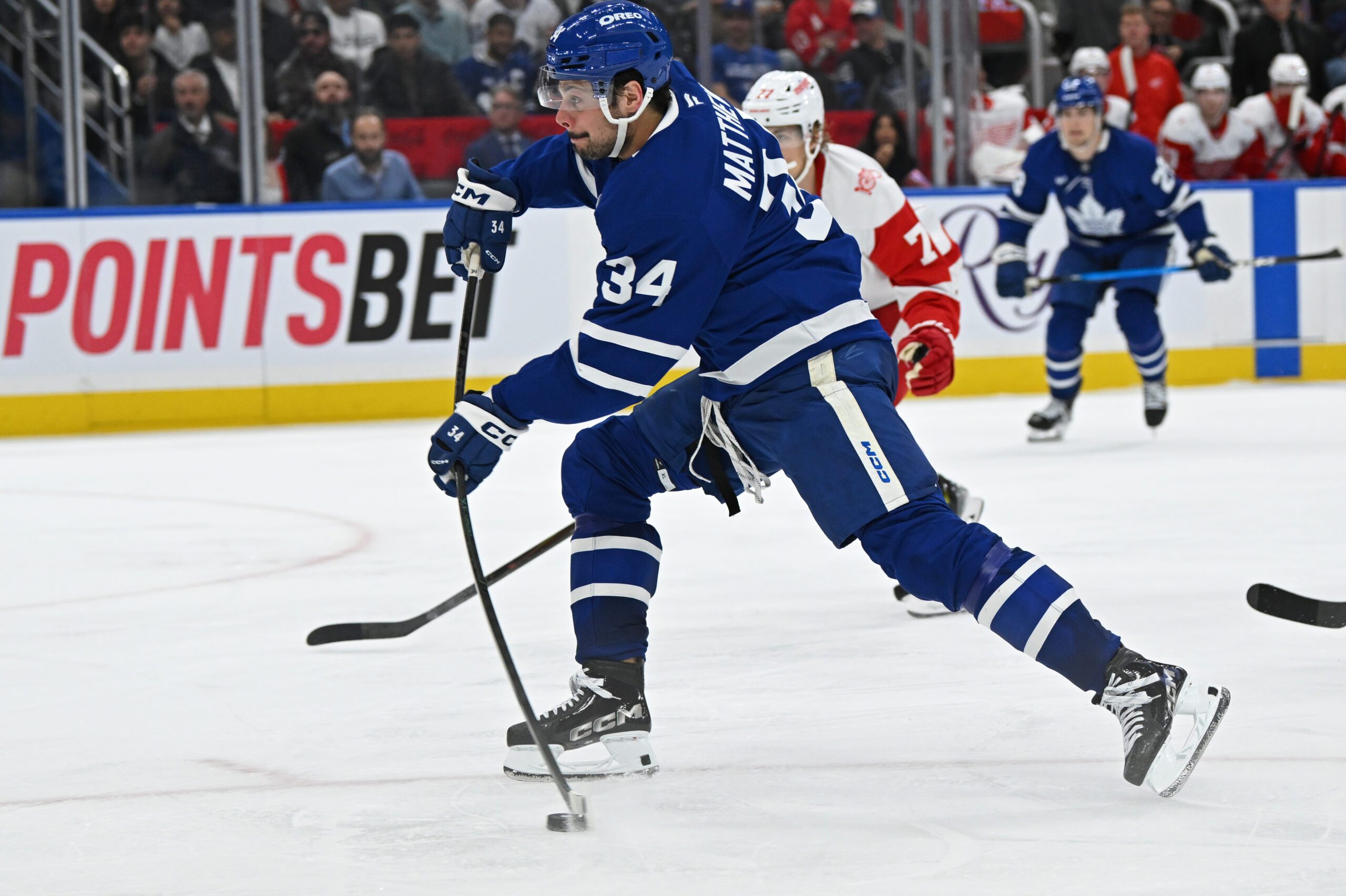 Oct 13, 2025; Toronto, Ontario, CAN; Toronto Maple Leafs center Auston Matthews (34) shoots on net against the Detroit Red Wings in the third period at Scotiabank Arena. Mandatory Credit: Gerry Angus-Imagn Images