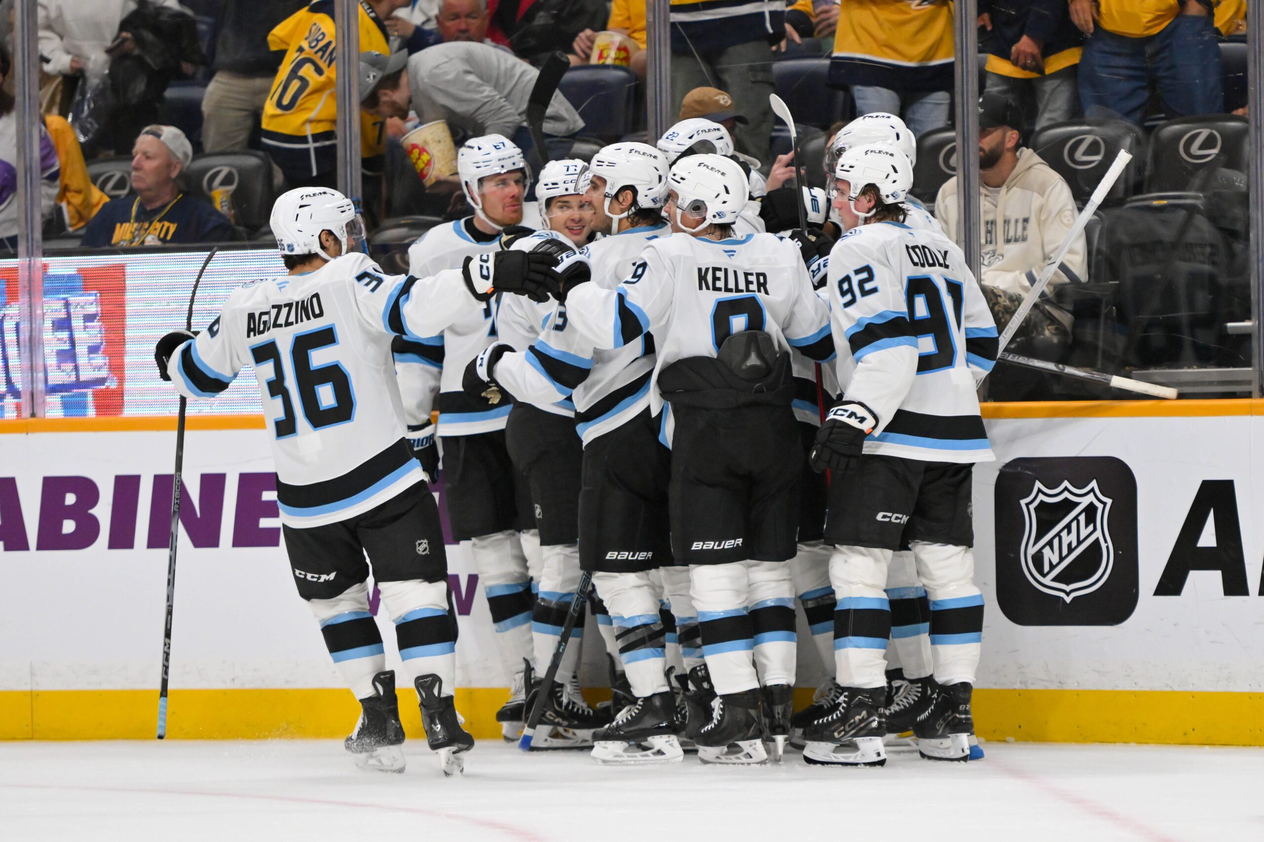 Oct 11, 2025; Nashville, Tennessee, USA;  Utah Mammoth right wing Dylan Guenther (11) celebrates with his teammates after scoring a goal after the game winning goal against the Nashville Predators during the overtime period at Bridgestone Arena. Mandatory Credit: Steve Roberts-Imagn Images