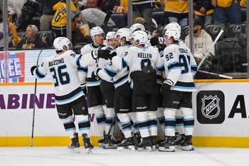 Oct 11, 2025; Nashville, Tennessee, USA;  Utah Mammoth right wing Dylan Guenther (11) celebrates with his teammates after scoring a goal after the game winning goal against the Nashville Predators during the overtime period at Bridgestone Arena. Mandatory Credit: Steve Roberts-Imagn Images
