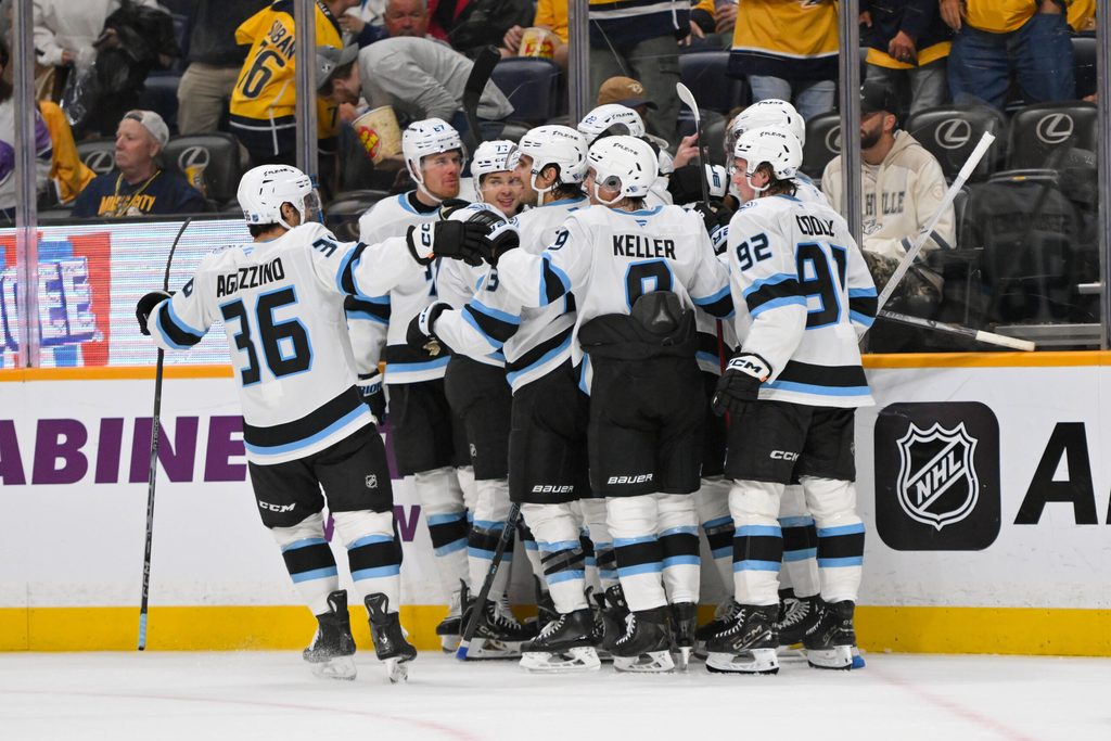 Oct 11, 2025; Nashville, Tennessee, USA; Utah Mammoth right wing Dylan Guenther (11) celebrates with his teammates after scoring a goal after the game winning goal against the Nashville Predators during the overtime period at Bridgestone Arena. Mandatory Credit: Steve Roberts-Imagn Images