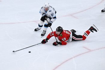 Oct 13, 2025; Chicago, Illinois, USA;  Chicago Blackhawks left wing Tyler Bertuzzi (59) and Utah Mammoth center Barrett Hayton (27) chase the puck during the second period at United Center. Mandatory Credit: Matt Marton-Imagn Images