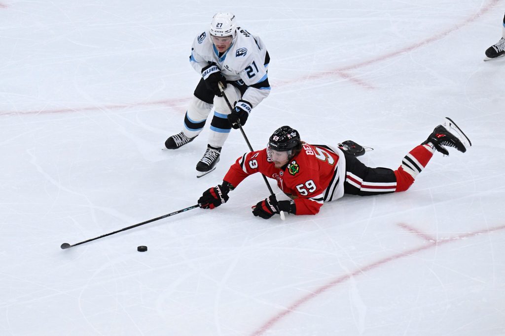 Oct 13, 2025; Chicago, Illinois, USA; Chicago Blackhawks left wing Tyler Bertuzzi (59) and Utah Mammoth center Barrett Hayton (27) chase the puck during the second period at United Center. Mandatory Credit: Matt Marton-Imagn Images