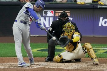 Los Angeles Dodgers first baseman Freddie Freeman (5) hits a solo home run during the sixth inning of their National League Championship Series game against the Milwaukee Brewers October 13, 2025 at American Family Field in Milwaukee, Wisconsin.