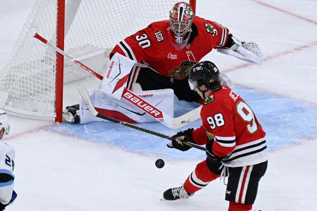 Oct 13, 2025; Chicago, Illinois, USA; Chicago Blackhawks goaltender Spencer Knight (30) and center Connor Bedard (98) defend against the Utah Mammoth during the second period at United Center. Mandatory Credit: Matt Marton-Imagn Images