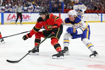 Oct 15, 2025; Buffalo, New York, USA;  Ottawa Senators center Dylan Cozens (24) skates to the net with the puck as Buffalo Sabres defenseman Rasmus Dahlin (26) defends during the first period at KeyBank Center. Mandatory Credit: Timothy T. Ludwig-Imagn Images