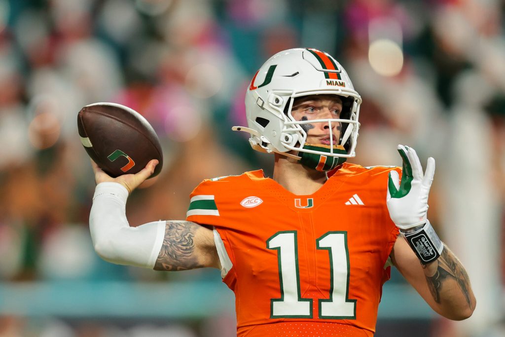 Oct 17, 2025; Miami Gardens, Florida, USA; Miami Hurricanes quarterback Carson Beck (11) throws the football against the Louisville Cardinals during the second quarter at Hard Rock Stadium. Mandatory Credit: Sam Navarro-Imagn Images
