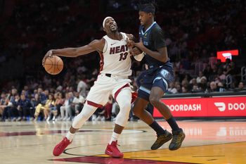 Oct 17, 2025; Miami, Florida, USA;  Memphis Grizzlies forward Olivier-Maxence Prosper (18) collides with Miami Heat center  Bam Adebayo (13) during the first half at Kaseya Center. Mandatory Credit: Jim Rassol-Imagn Images