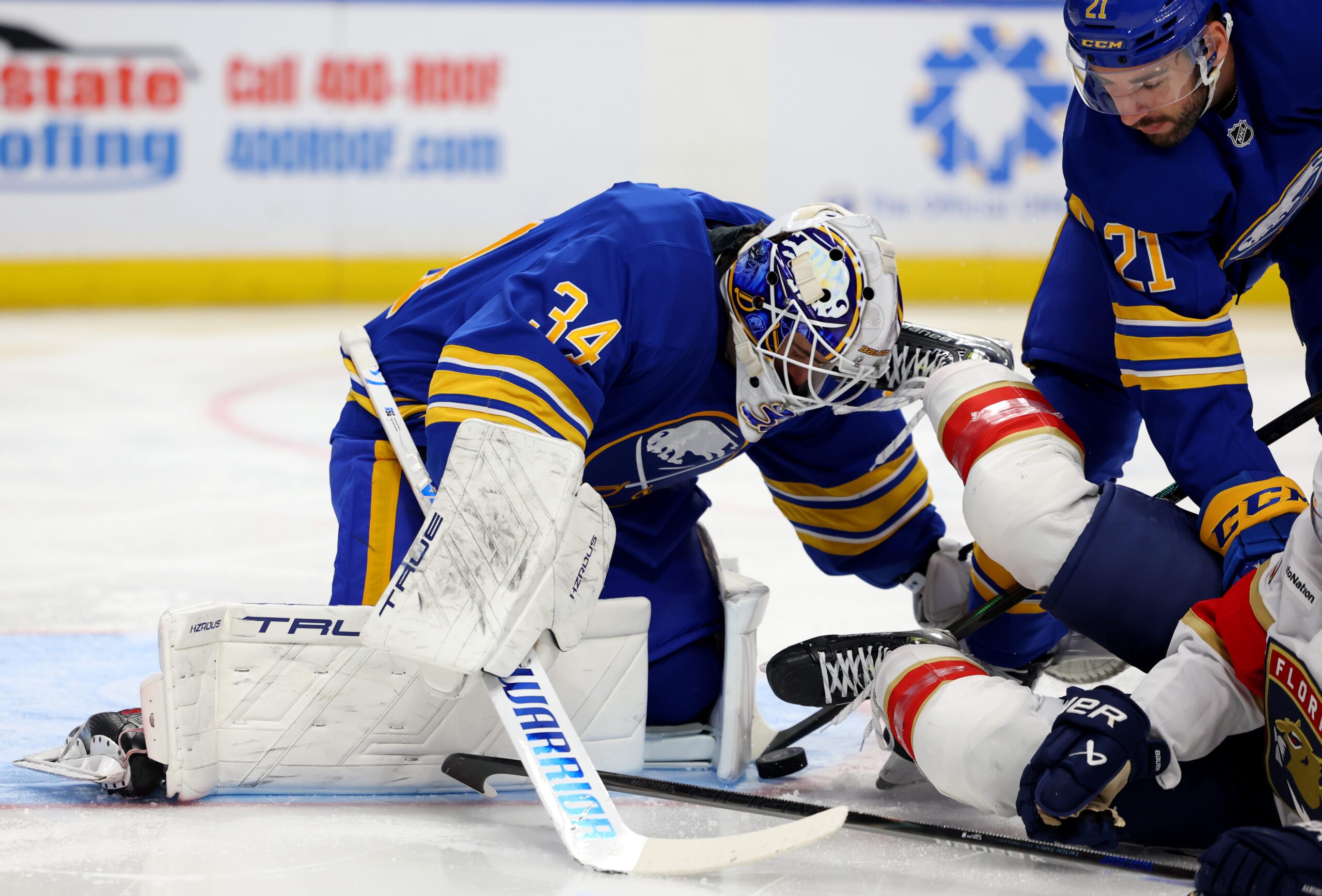 Oct 18, 2025; Buffalo, New York, USA;  Buffalo Sabres goaltender Alex Lyon (34) makes a save and looks to cover up the puck during the first period against the Florida Panthers at KeyBank Center. Mandatory Credit: Timothy T. Ludwig-Imagn Images