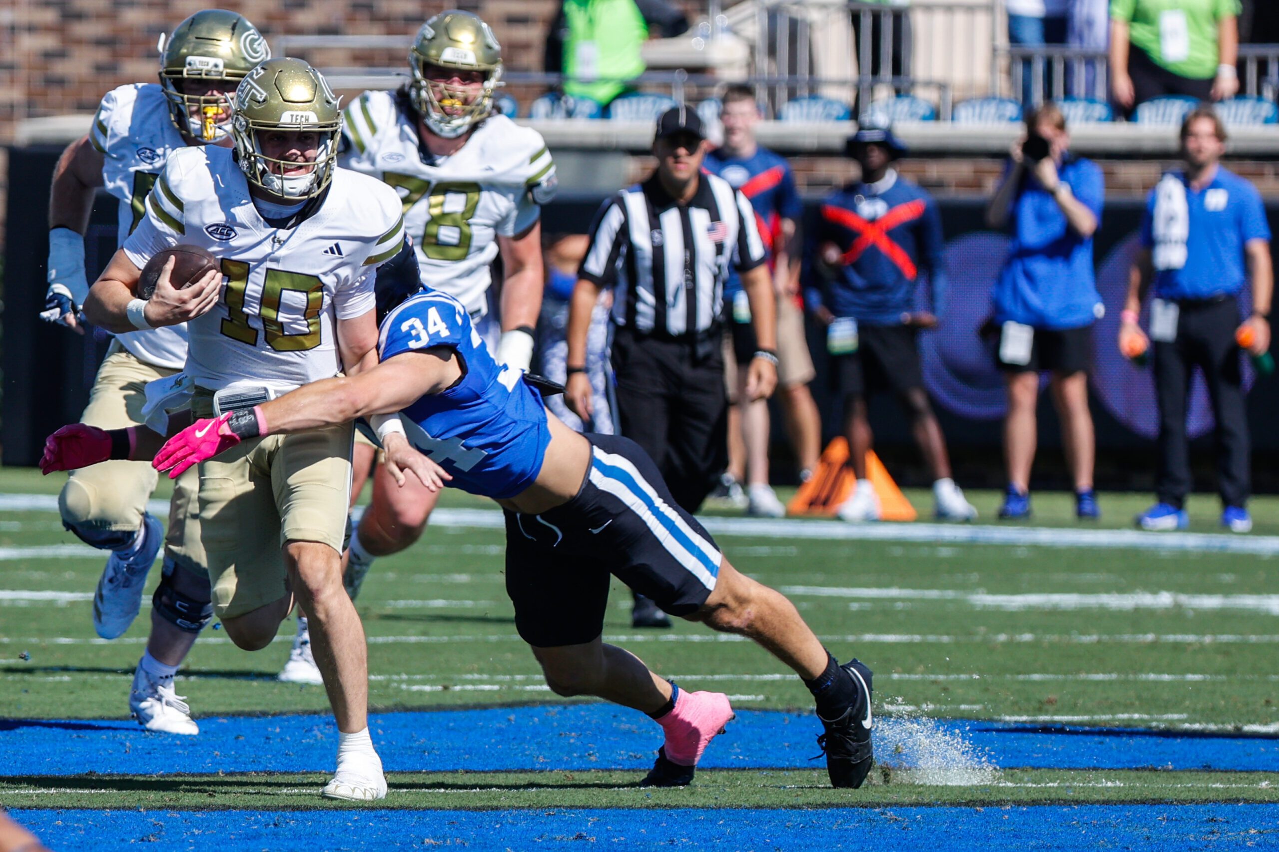 Oct 18, 2025; Durham, North Carolina, USA;   Duke Blue Devils linebacker Luke Mergott (34) tackles Georgia Tech Yellow Jackets quarterback Haynes King (10) during the first half of the game at Wallace Wade Stadium. Mandatory Credit: Jaylynn Nash-Imagn Images