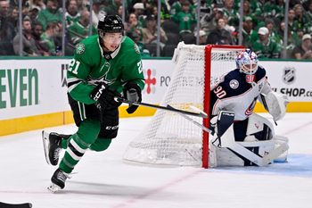 Oct 21, 2025; Dallas, Texas, USA; Dallas Stars left wing Jason Robertson (21) skates past Columbus Blue Jackets goaltender Elvis Merzlikins (90) during the game between the Stars and the Blue Jackets at the American Airlines Center. Mandatory Credit: Jerome Miron-Imagn Images