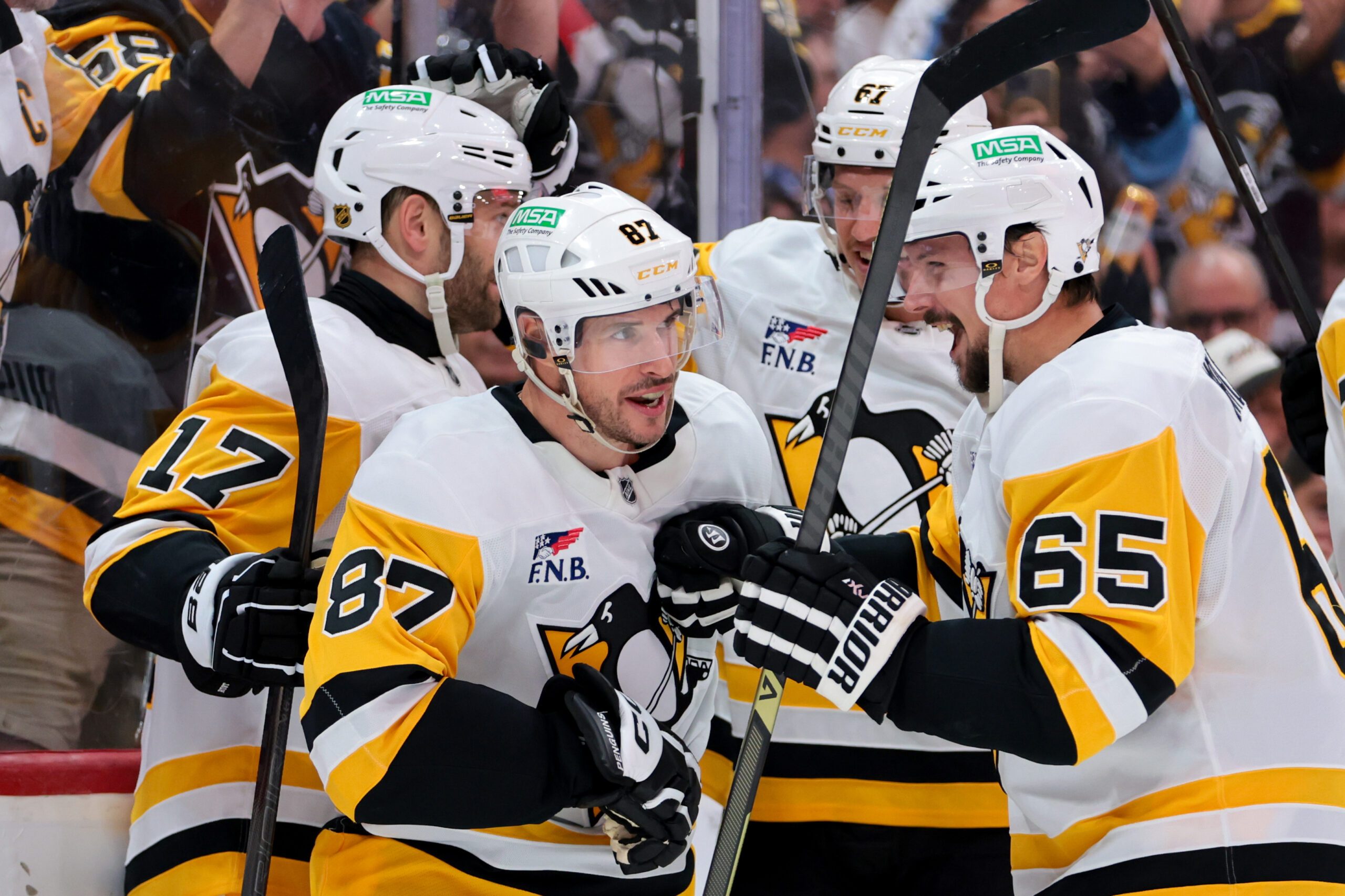 Oct 23, 2025; Sunrise, Florida, USA; Pittsburgh Penguins center Sidney Crosby (87) celebrates with defenseman Erik Karlsson (65) after scoring against the Florida Panthers during the third period at Amerant Bank Arena. Mandatory Credit: Sam Navarro-Imagn Images