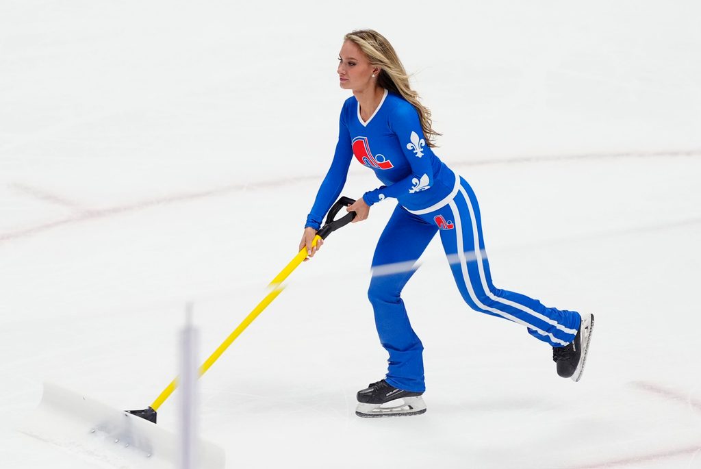 Oct 23, 2025; Denver, Colorado, USA; Colorado Avalanche ice patrol Sydney Browne clears the rink in the third period against the Carolina Hurricanes at Ball Arena. Mandatory Credit: Ron Chenoy-Imagn Images