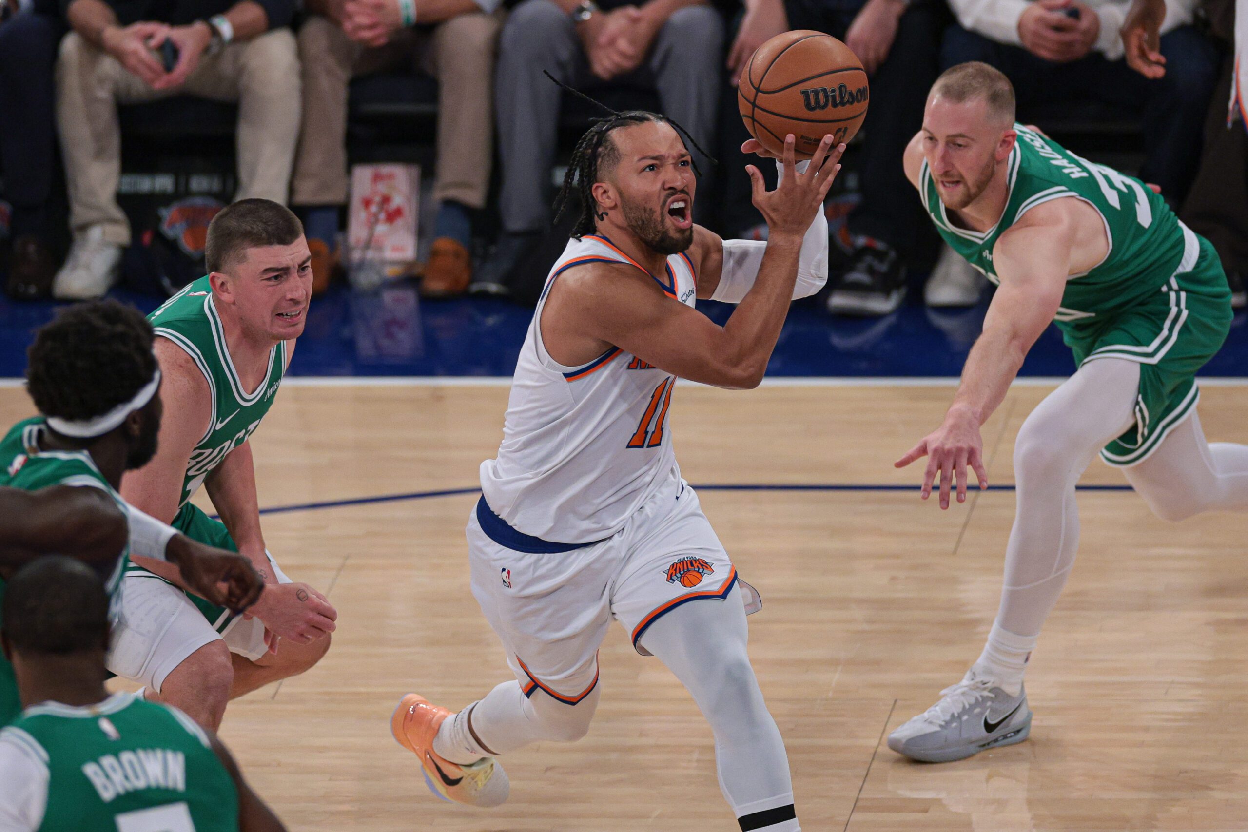 Oct 24, 2025; New York, New York, USA;  New York Knicks guard Jalen Brunson (11) goes to the basket in front of Boston Celtics forward Sam Hauser (30) during the first quarter at Madison Square Garden. Mandatory Credit: Vincent Carchietta-Imagn Images