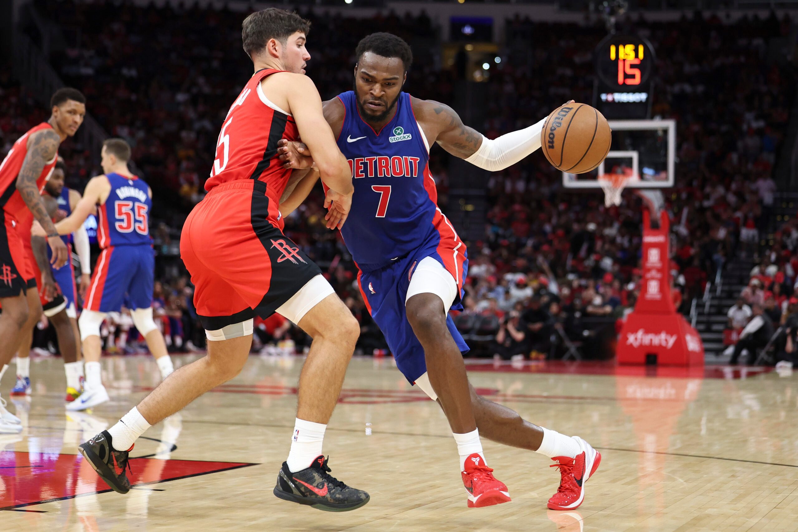 Oct 24, 2025; Houston, Texas, USA; Detroit Pistons forward Paul Reed (7) drives with the ball as Houston Rockets guard Reed Sheppard (15) defends during the fourth quarter at Toyota Center. Mandatory Credit: Troy Taormina-Imagn Images