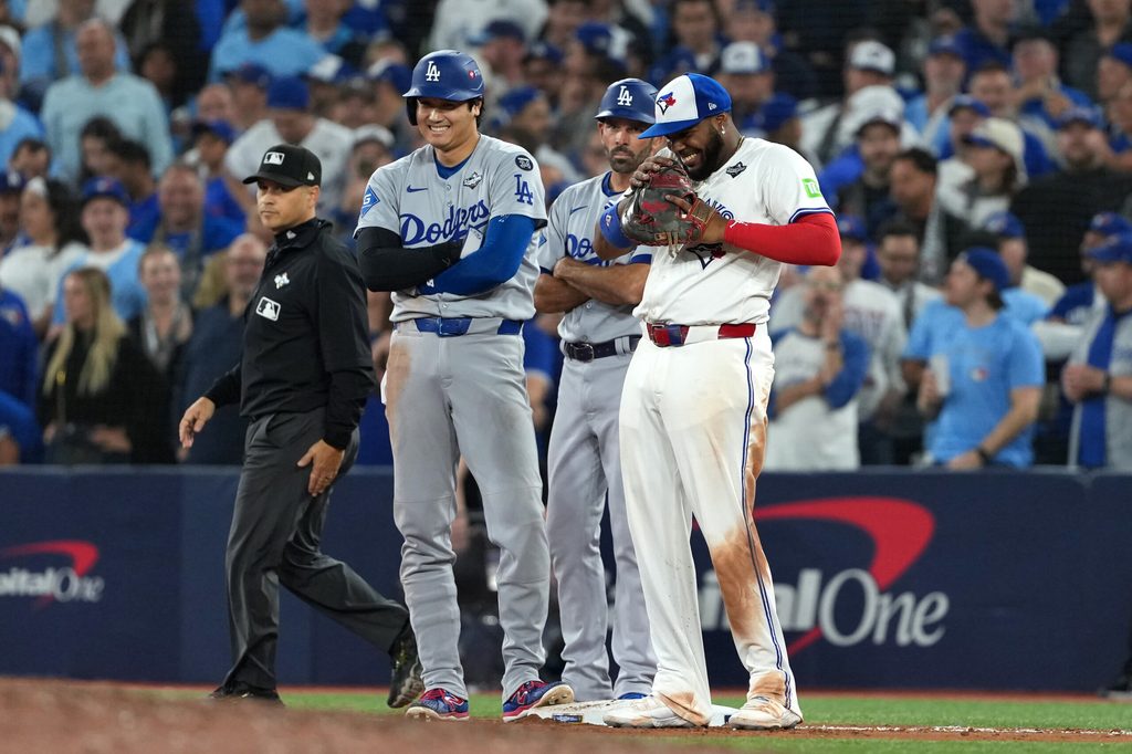 Oct 24, 2025; Toronto, Ontario, CAN; Los Angeles Dodgers two-way player Shohei Ohtani (17) and Toronto Blue Jays first baseman Vladimir Guerrero Jr. (27) react in the ninth inning during game one of the 2025 MLB World Series at Rogers Centre. Mandatory Credit: Nick Turchiaro-Imagn Images