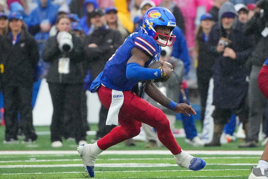 Oct 25, 2025; Lawrence, Kansas, USA; Kansas Jayhawks quarterback Jalon Daniels (6) runs the ball against the Kansas State Wildcats during the second half of the game at David Booth Kansas Memorial Stadium. Mandatory Credit: Denny Medley-Imagn Images