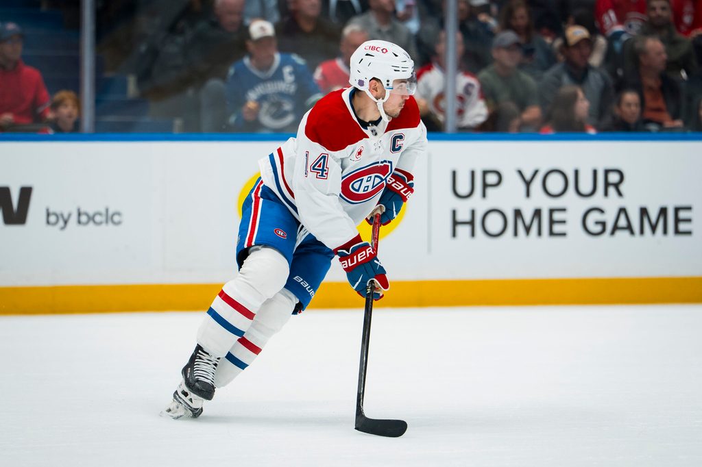 Oct 25, 2025; Vancouver, British Columbia, CAN; Montreal Canadiens forward Nick Suzuki (14) handles the puck against the Vancouver Canucks in the second period at Rogers Arena. Mandatory Credit: Bob Frid-Imagn Images